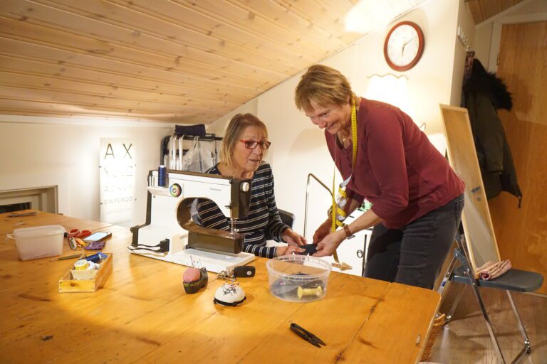 Inne på naustloftet har damene innredet ordnet til en systue for anledningen.||Fv. Kari Edvardsen og Bjørg Strandheim Nilsen|mange runder med måltaking og prøving ble det jo også.